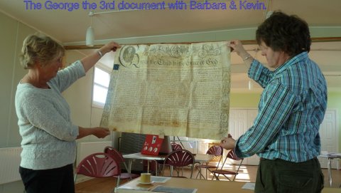 Barbara Mapplesden and Kevin Cale holding a document signed by George III
